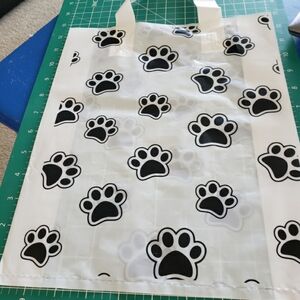 Set of 10 white plastic bags  with black prints.
